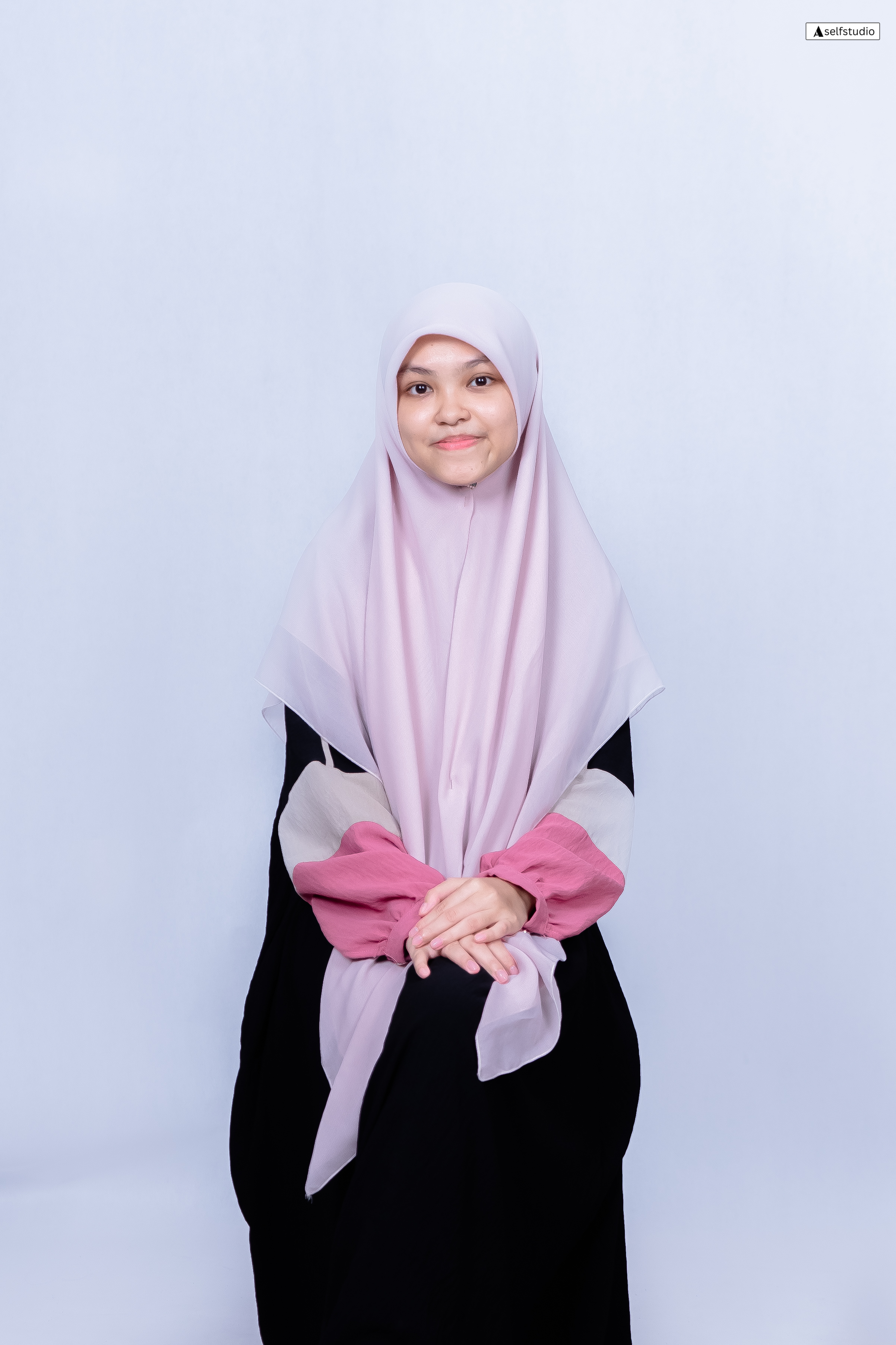 Profile illustration of a man with briefcase standing next to a desk with computer, plant, and clock